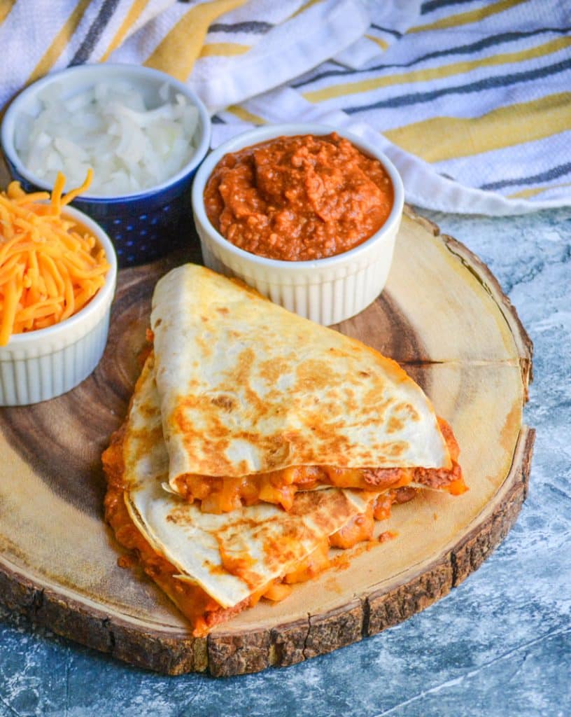slices of chili cheese dog quesadillas on a wooden cutting board