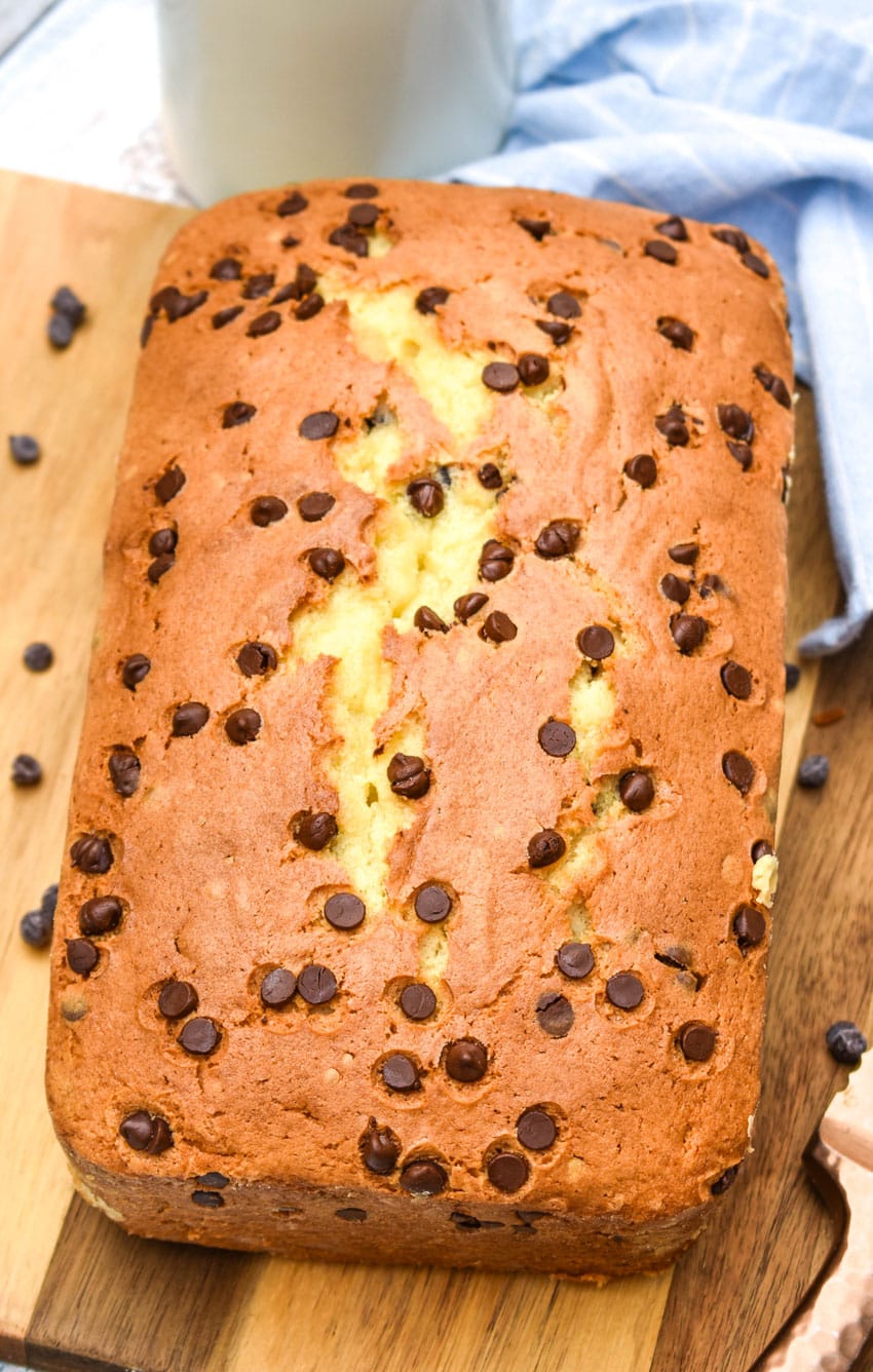 chocolate chip pound cake sitting on a wooden cutting board