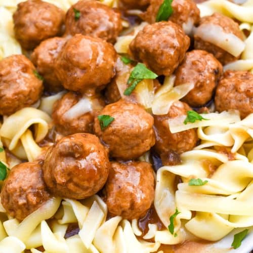 instant pot french onion meatballs over egg noodles on a white plate