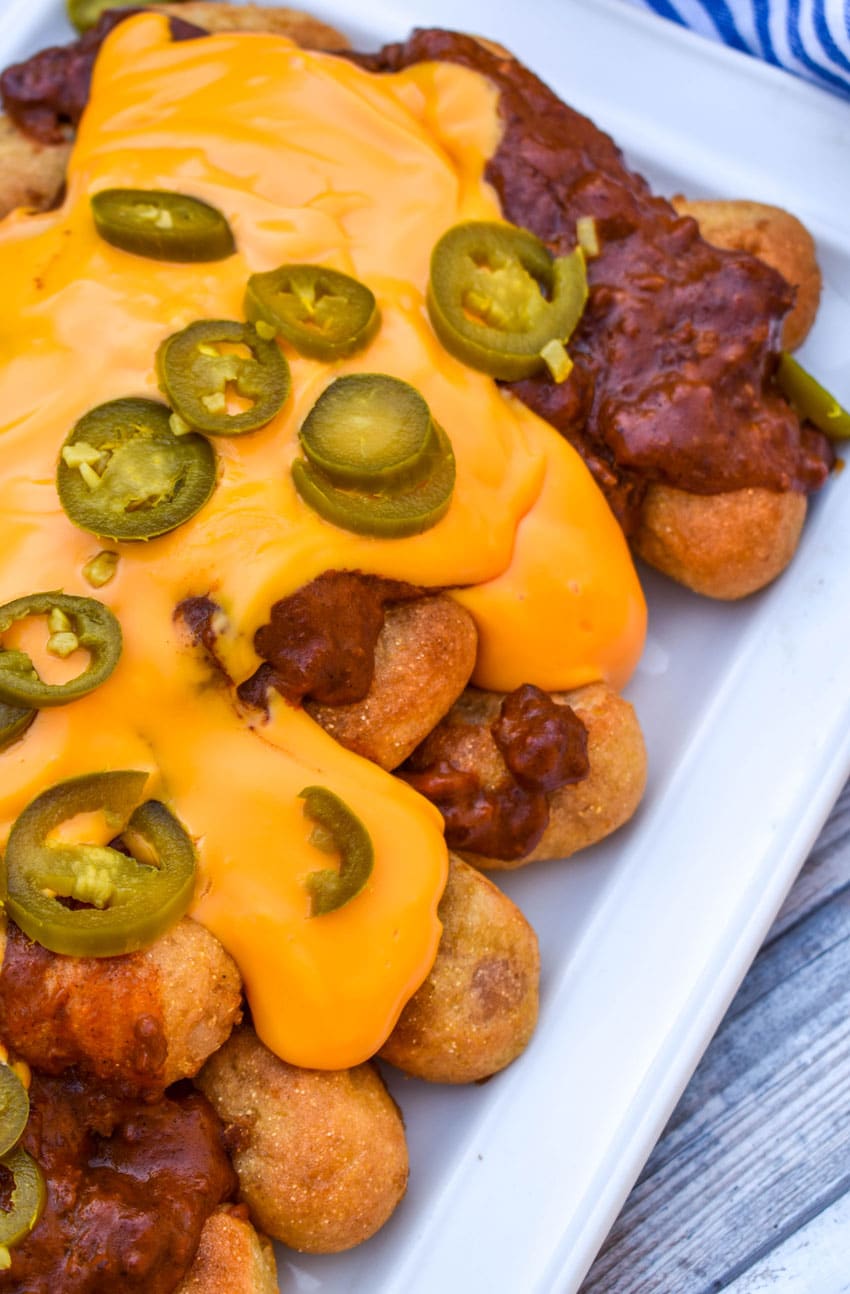 loaded corn dog nugget nachos on a white serving platter