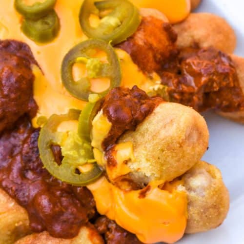 loaded corn dog nugget nachos on a white serving platter