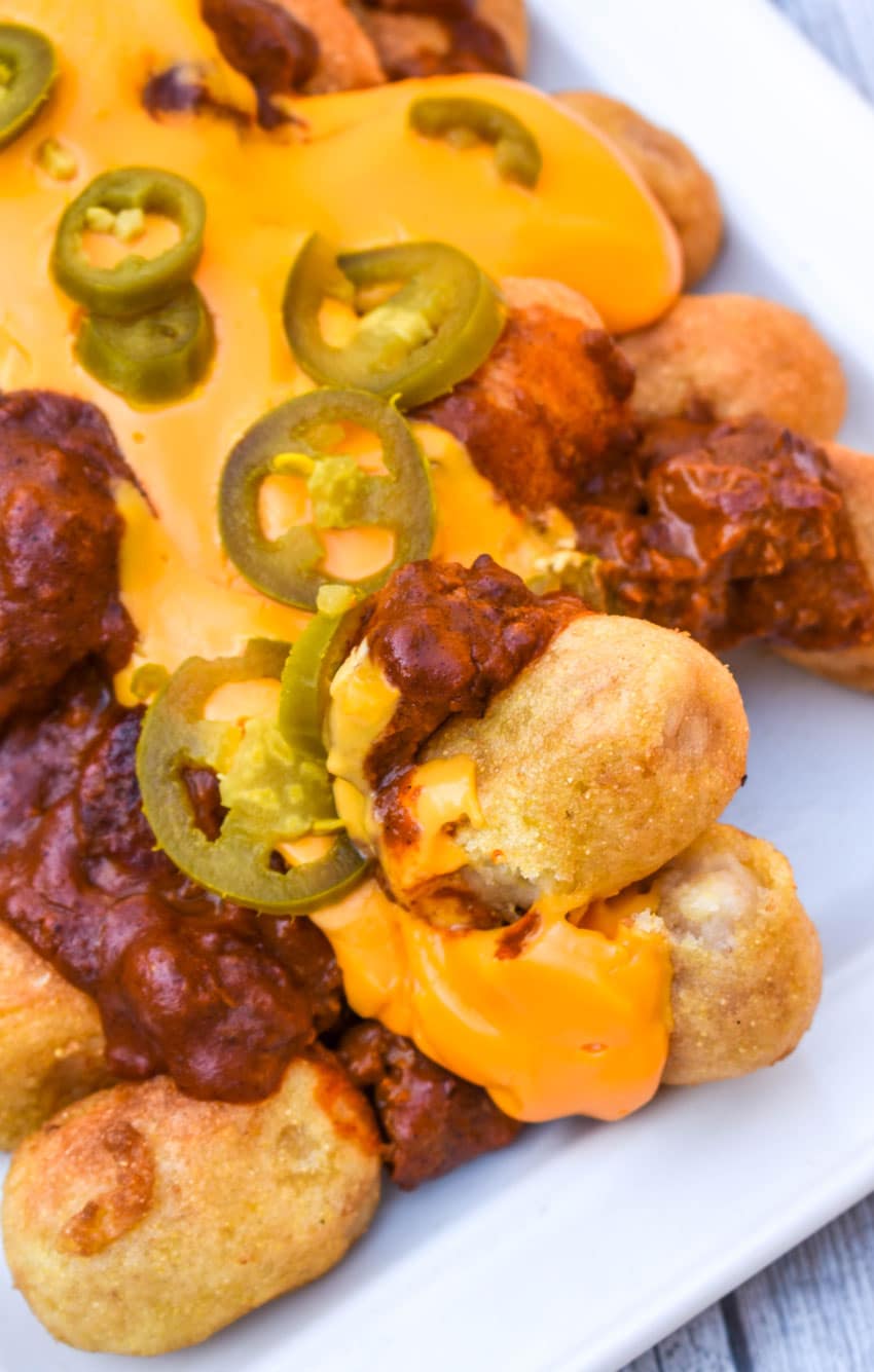 loaded corn dog nugget nachos on a white serving platter
