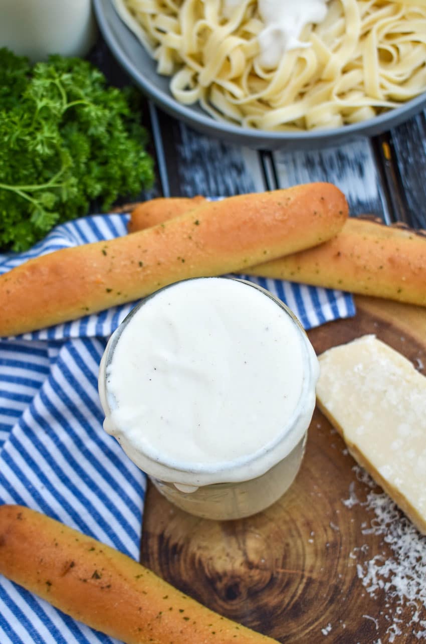 easy homemade alfredo sauce recipe in a glass mason jar