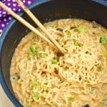 shaq ramen noodle hack recipe in a black skillet with wooden chop sticks on the side