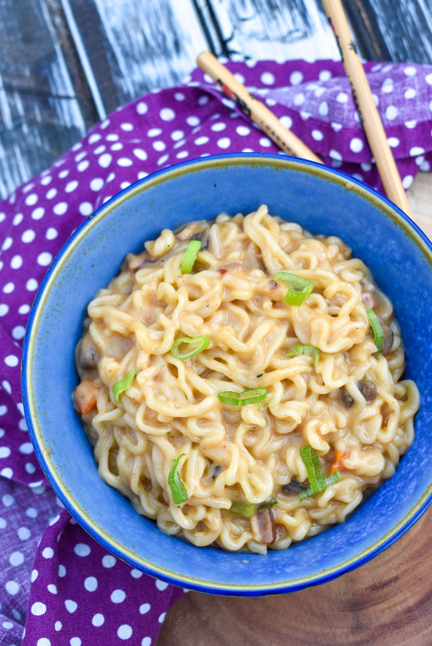 shaq ramen noodle hack recipe in a blue bowl with wooden chop sticks on the side