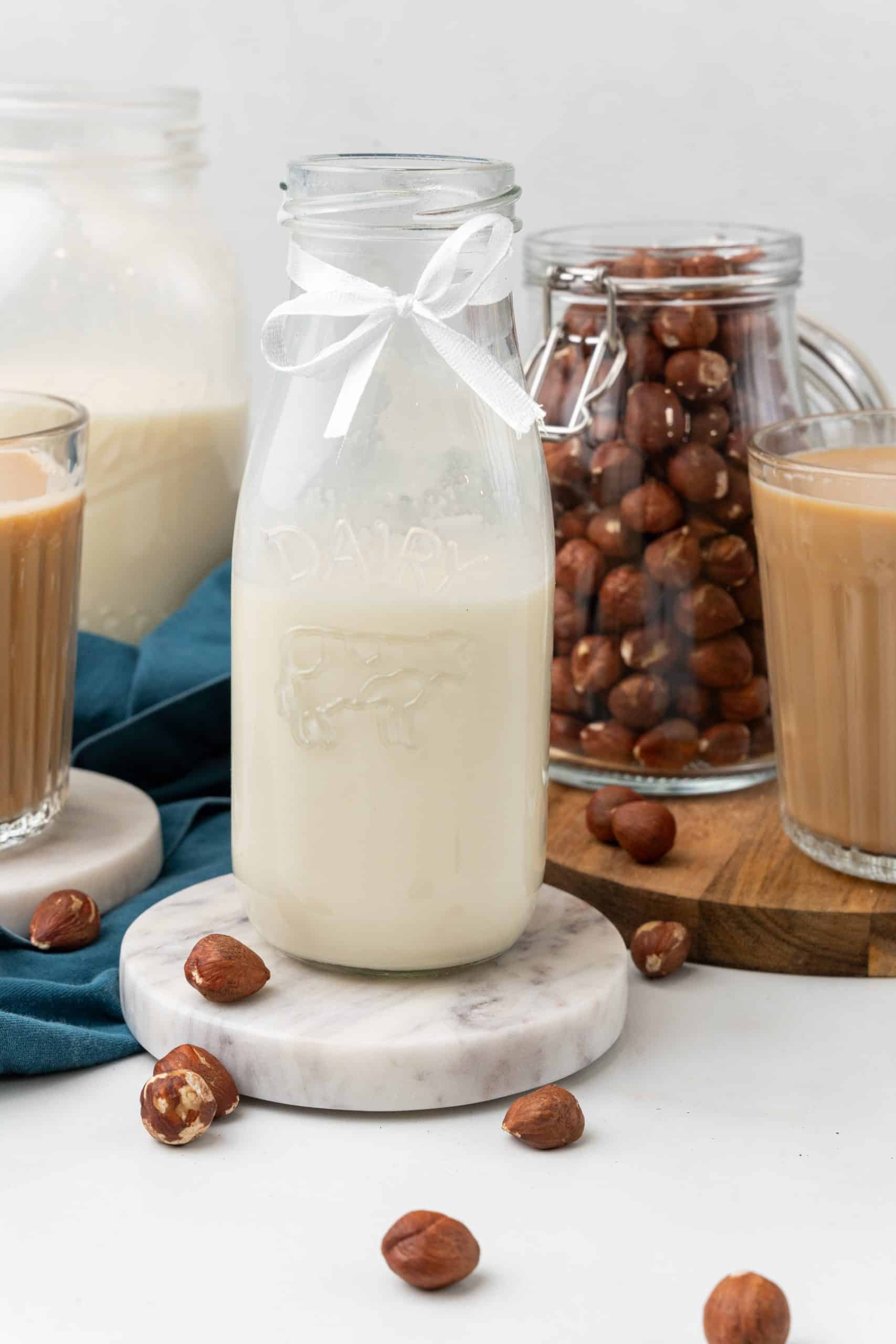 homemade hazelnut coffee creamer in a glass jar on a marble coaster
