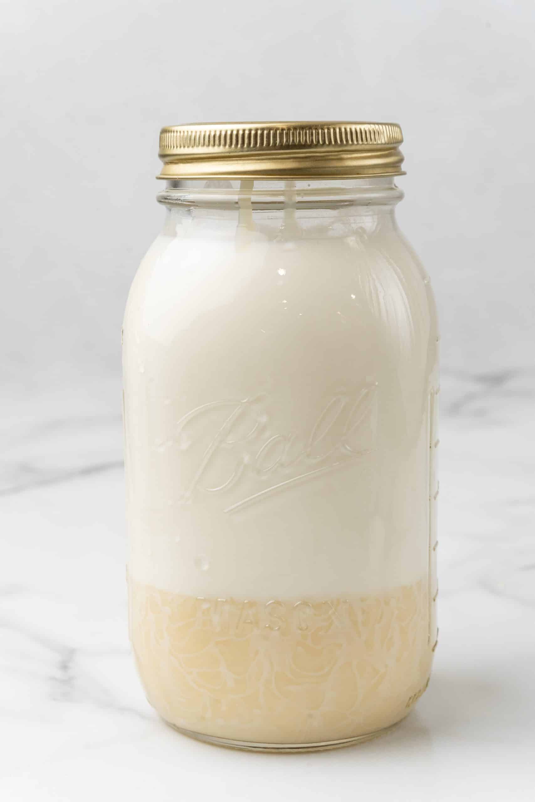 condensed milk and milk in a sealed glass mason jar