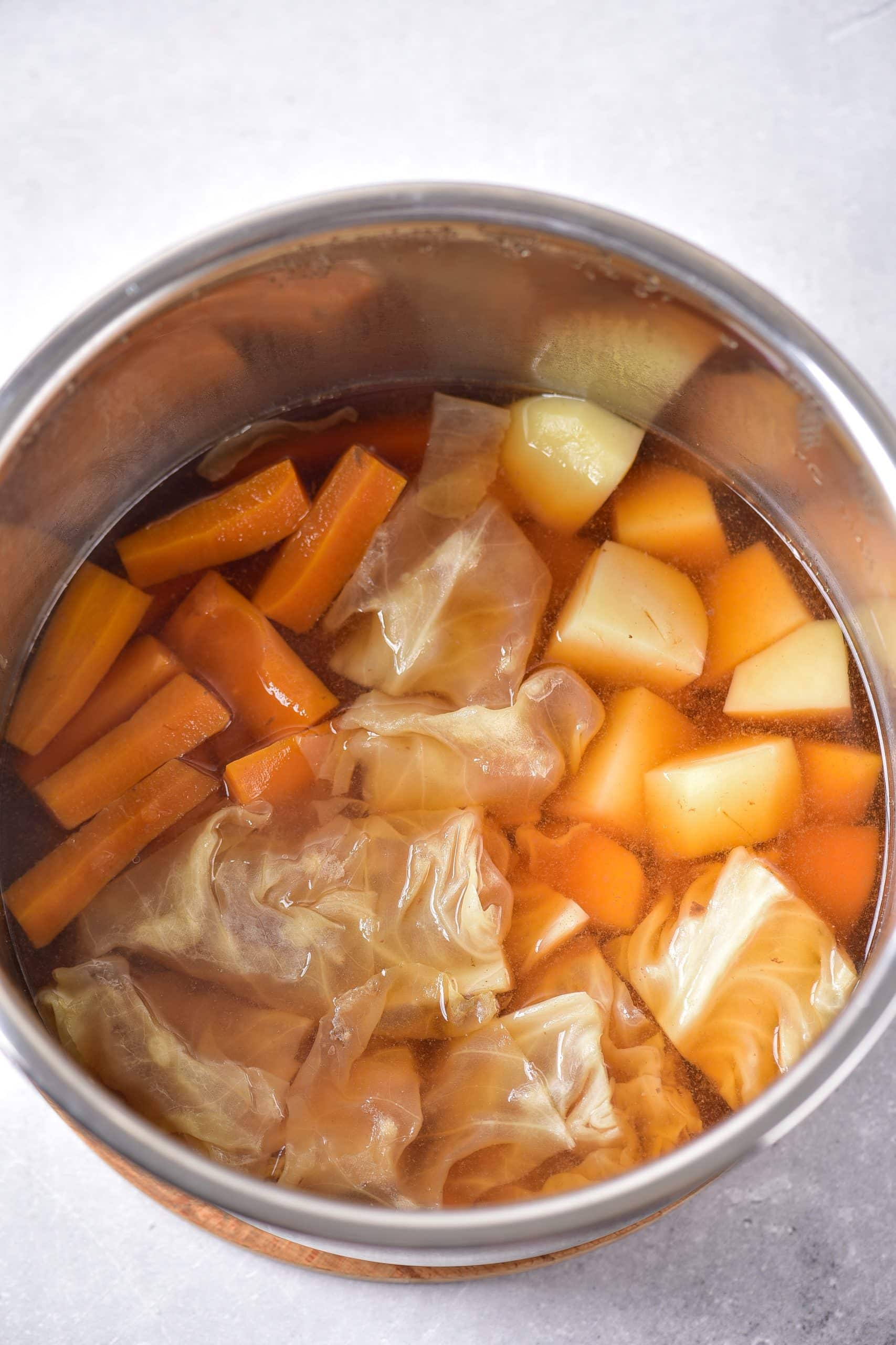 cooked cabbage, potatoes, and carrots in the bowl of an instant pot