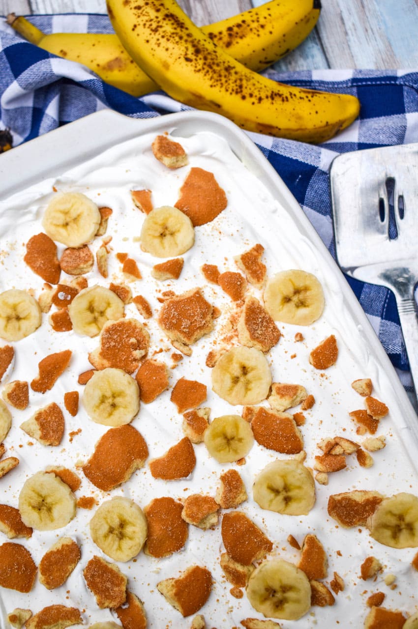 banana pudding poke cake in a white baking dish