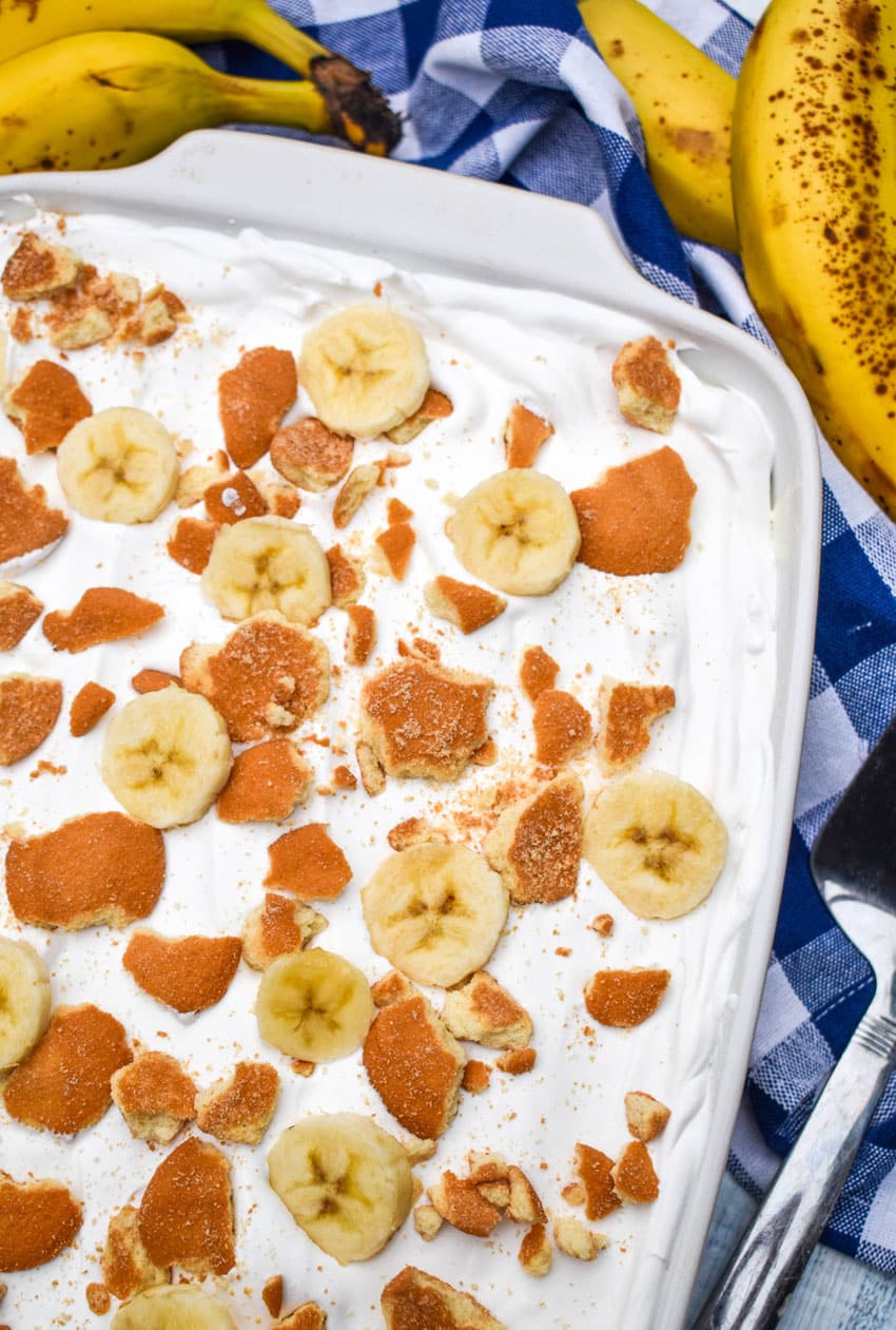 banana pudding poke cake in a white baking dish