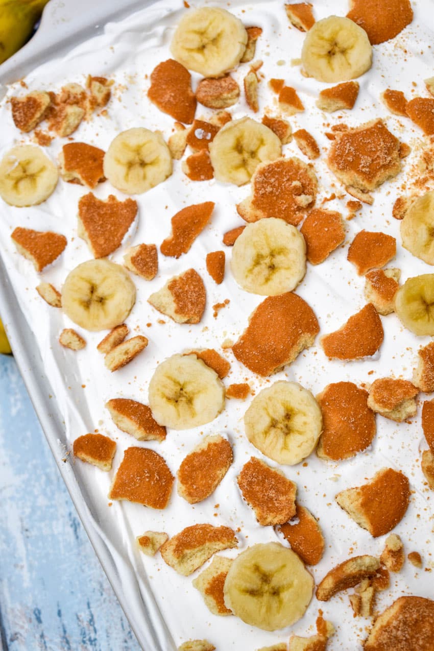 banana pudding poke cake in a white baking dish