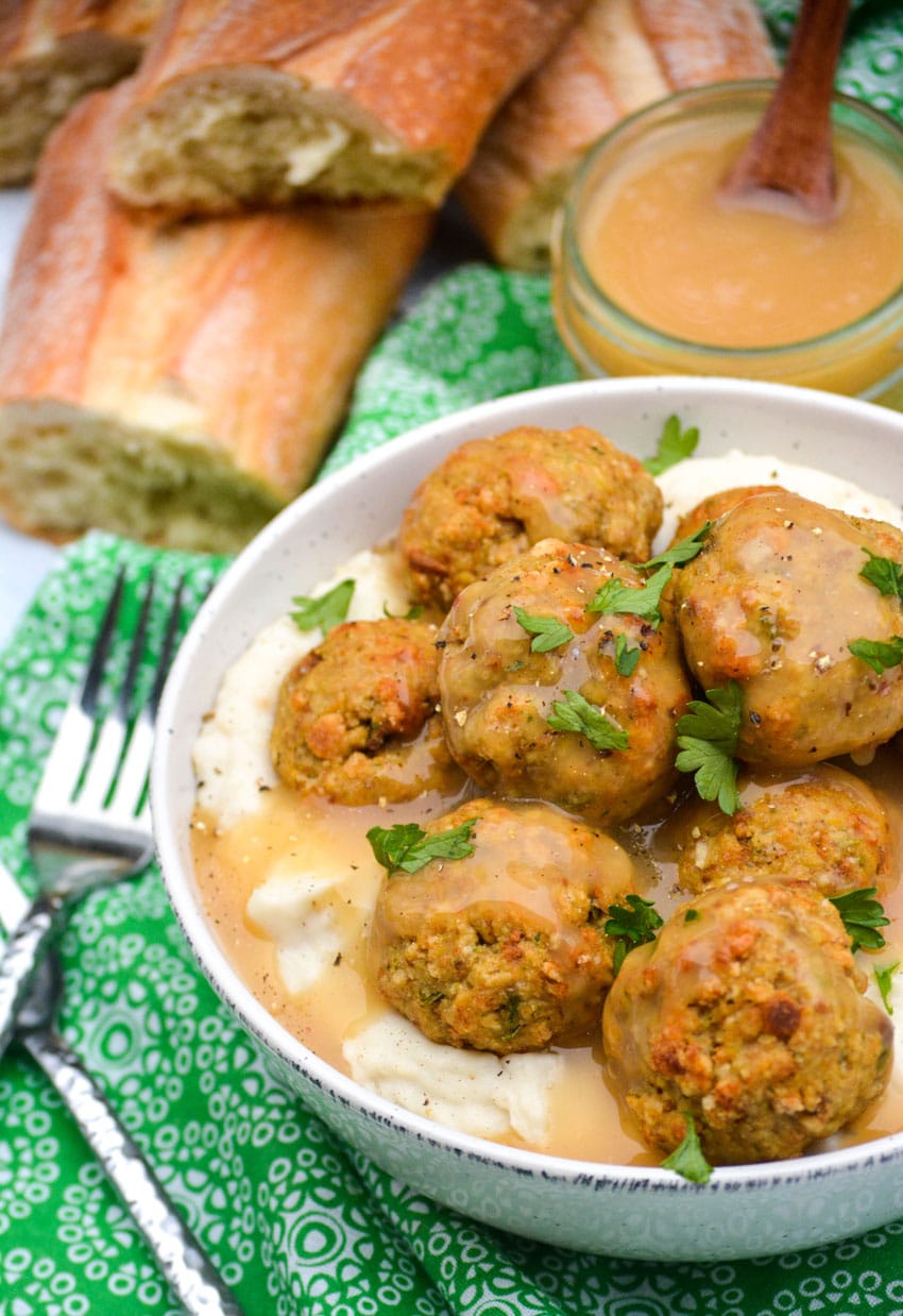 easy chicken meatballs with stuffing mix in a white bowl with mashed potatoes and gravy