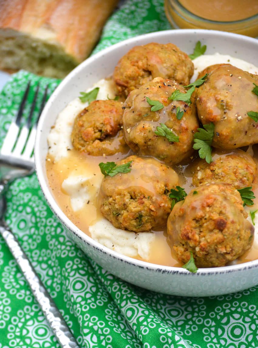 Easy Chicken Meatballs With Stuffing Mix easy chicken meatballs with stuffing mix in a white bowl with mashed potatoes and gravy