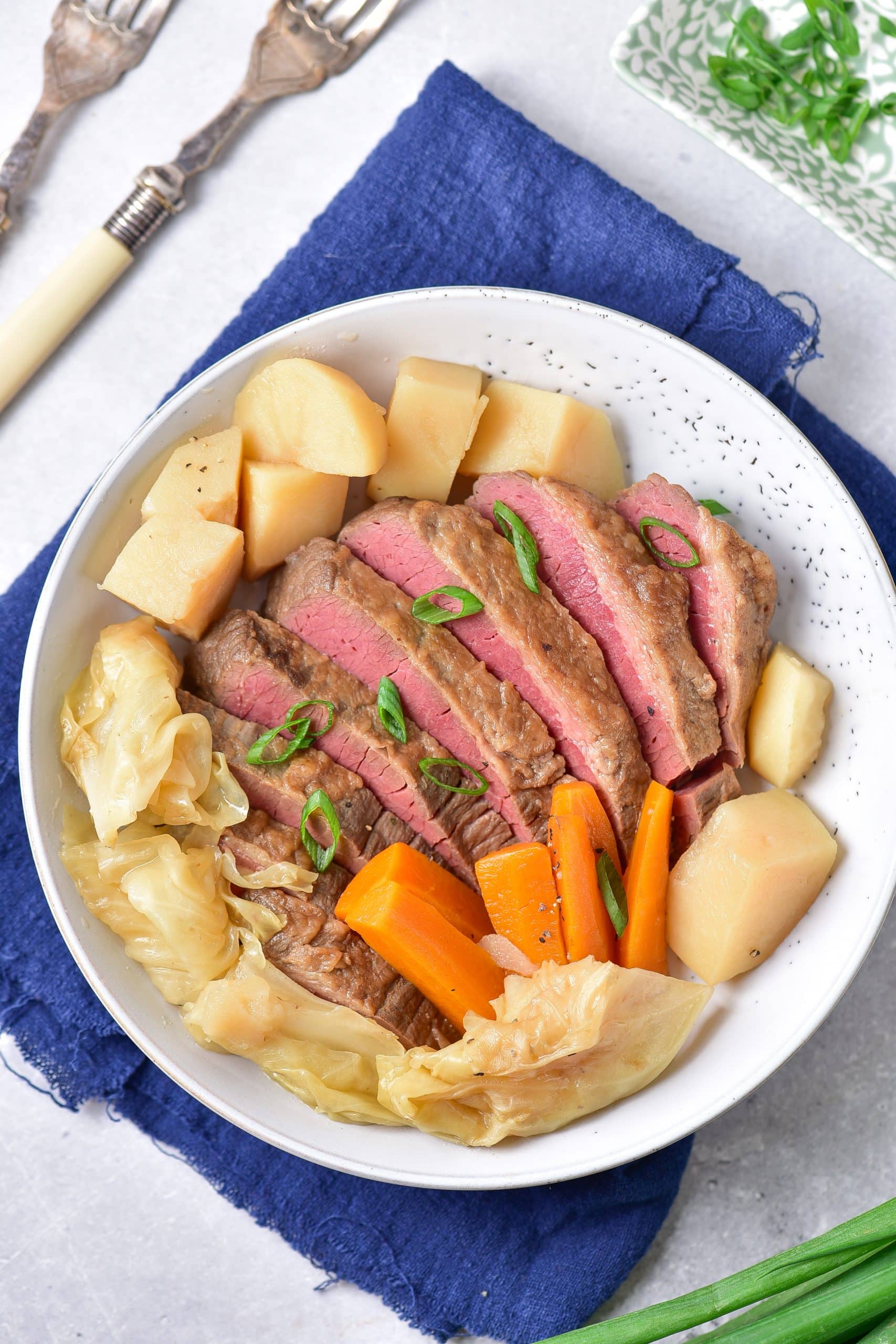 instant pot corned beef and cabbage in a shallow white bowl