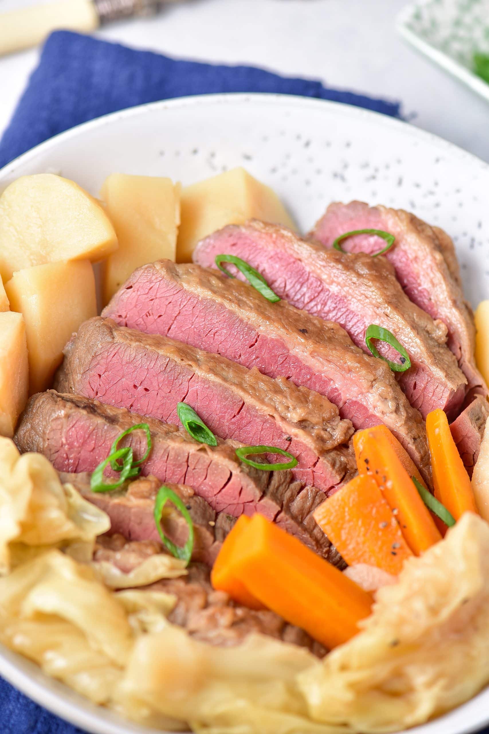 instant pot corned beef and cabbage in a shallow white bowl