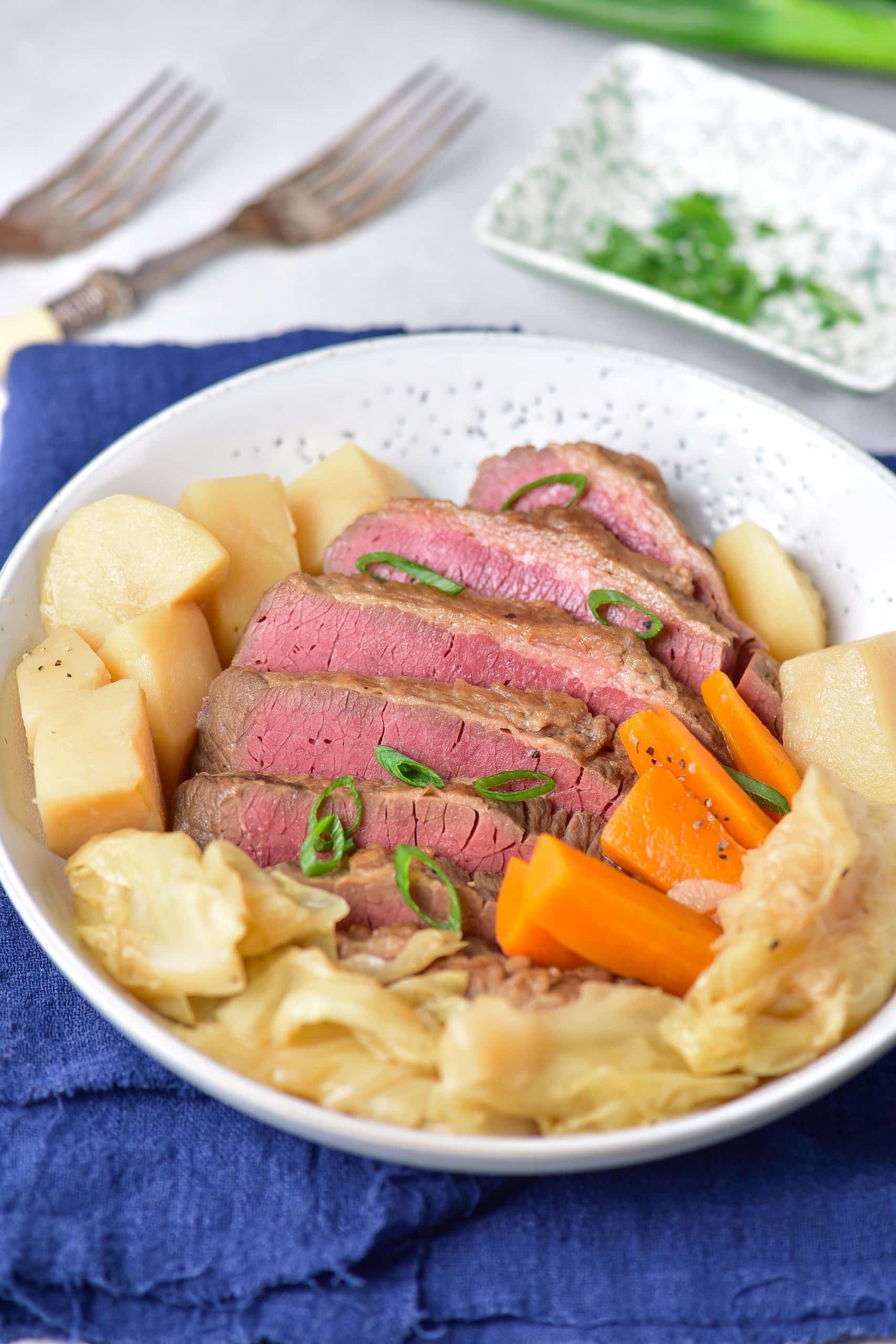 instant pot corned beef and cabbage in a shallow white bowl