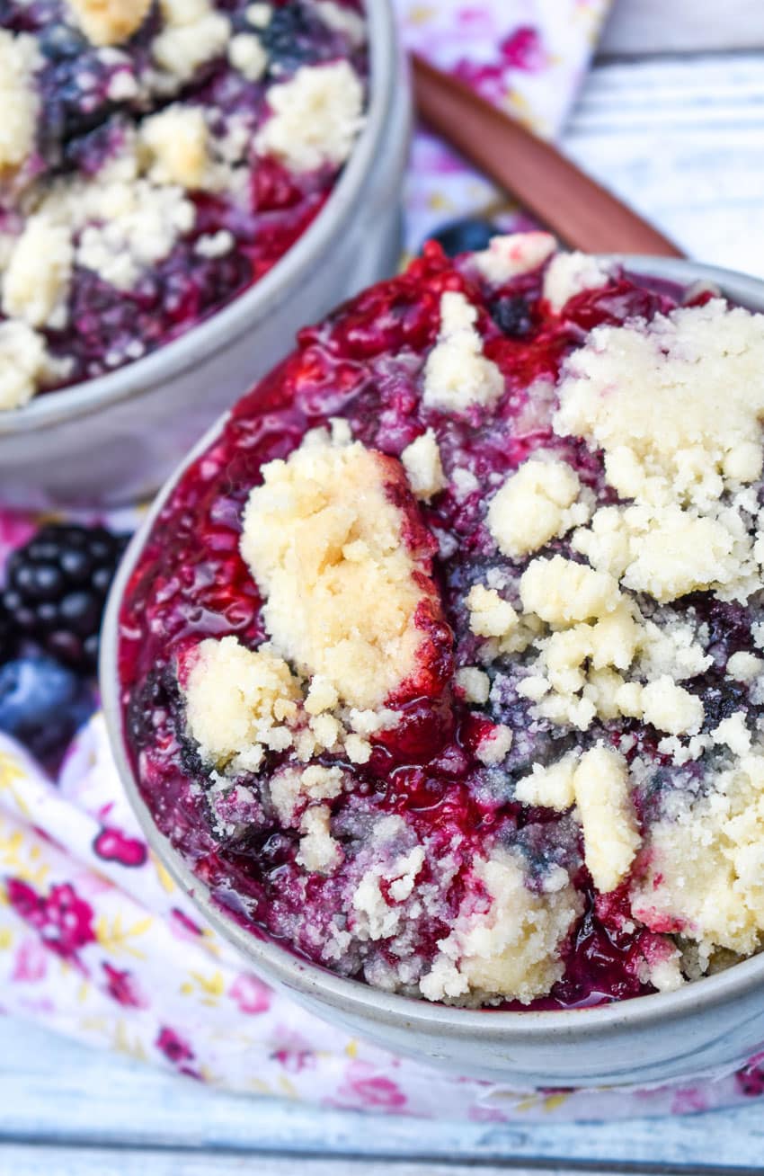 dump and bake berry cobbler with sugar cookie crust in a small gray bowl