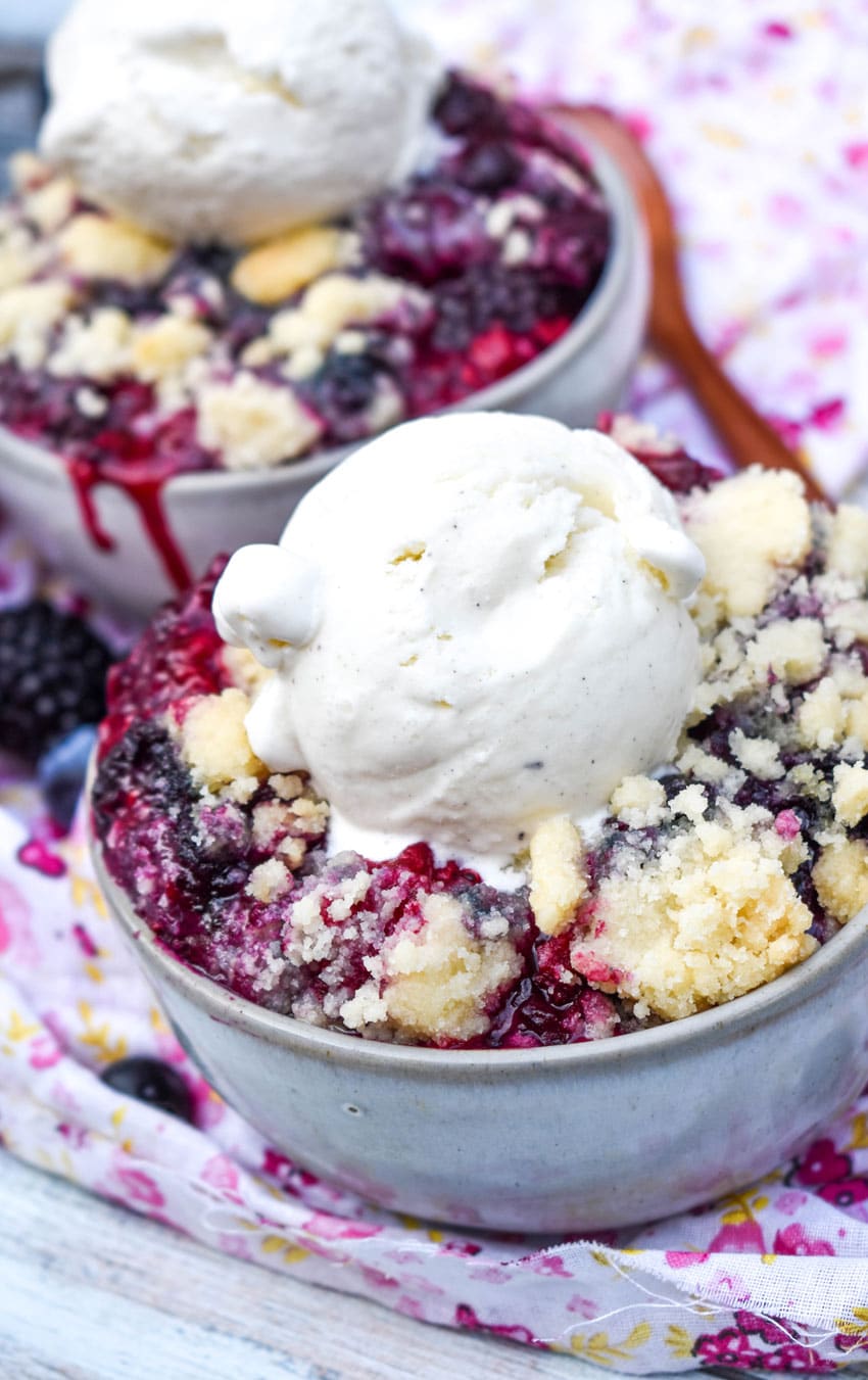 Sugar Cookie Berry Cobbler (Dump & Bake Recipe) sugar cookie berry cobbler in gray bowls topped with scoops of vanilla ice cream