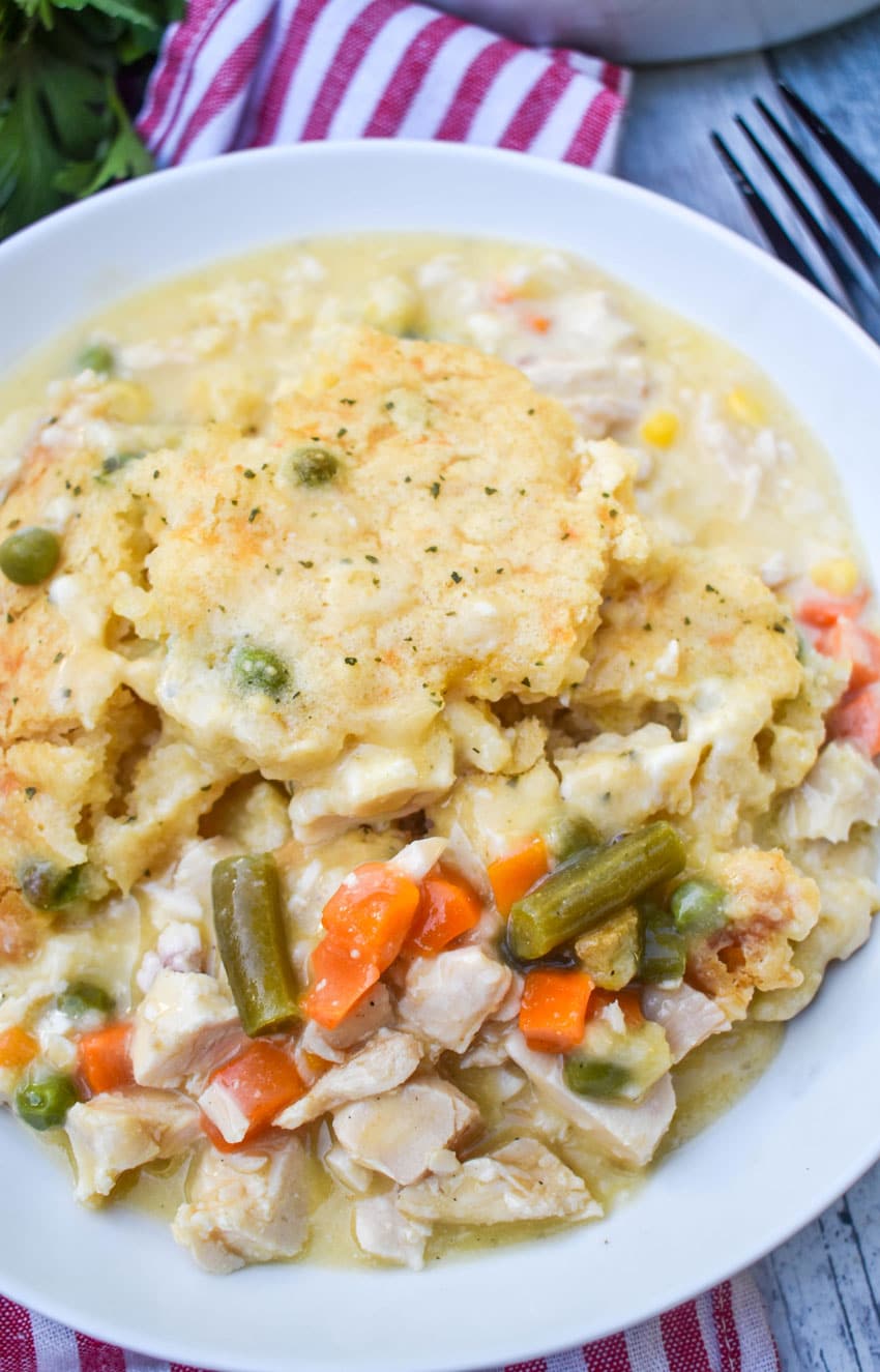 scoops of easy chicken cobbler with vegetables in a shallow white bowl