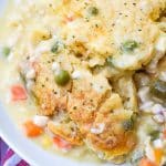 scoops of easy chicken cobbler with vegetables in a shallow white bowl