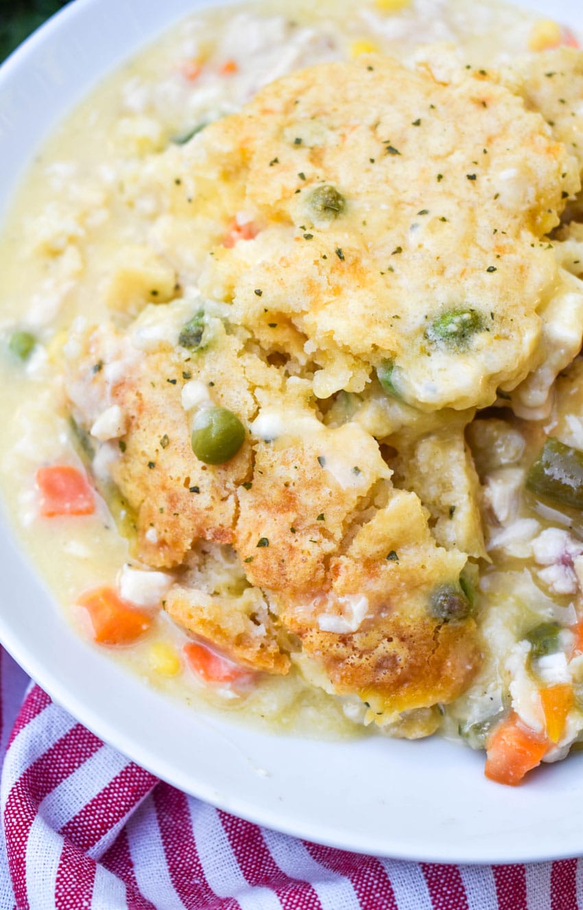 scoops of easy chicken cobbler with vegetables in a shallow white bowl