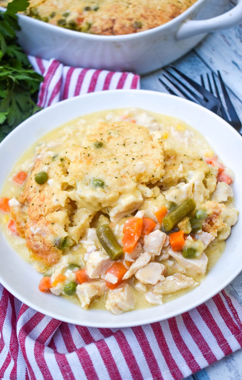 scoops of easy chicken cobbler with vegetables in a shallow white bowl