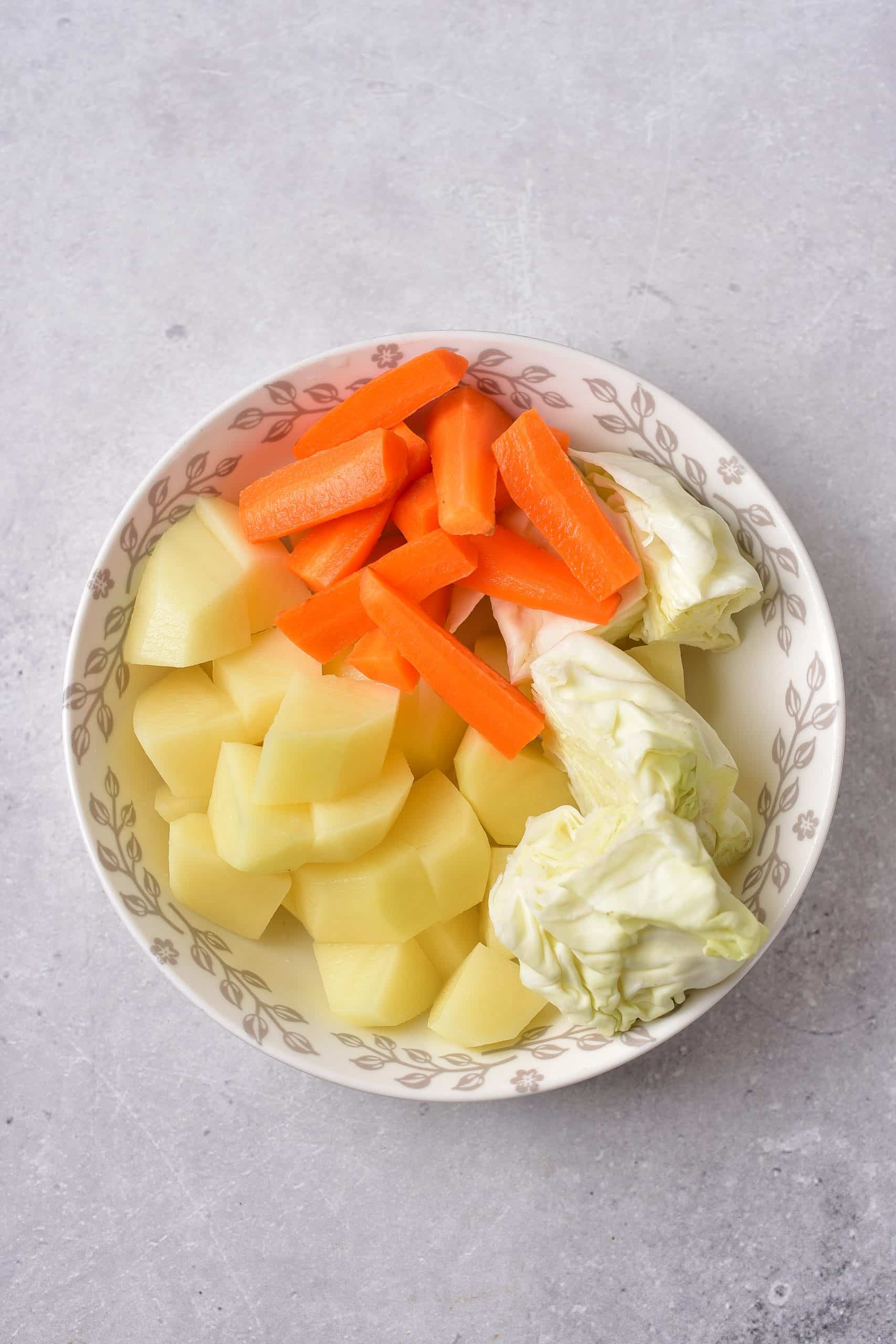an overhead image showing the prepped vegetables for making corned beef and cabbage in the instant pot