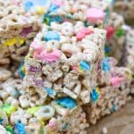 a stack of lucky charms treats on wrinkled brown parchment paper
