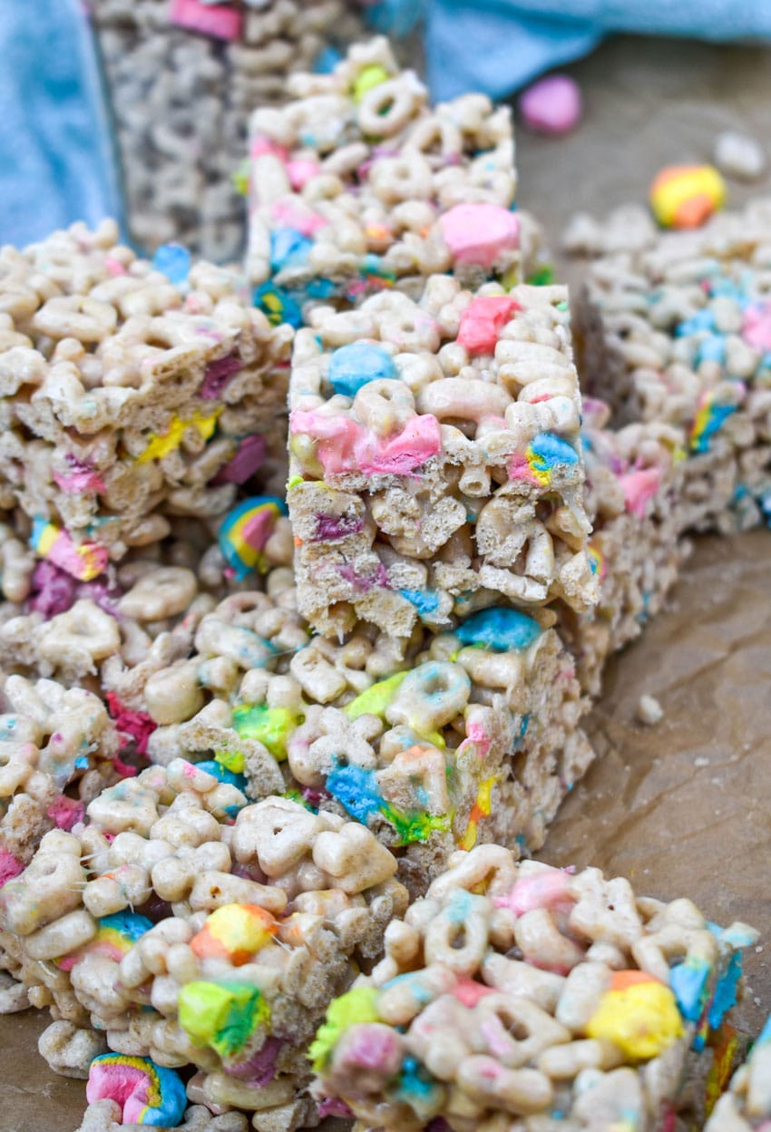 a stack of lucky charms treats on wrinkled brown parchment paper