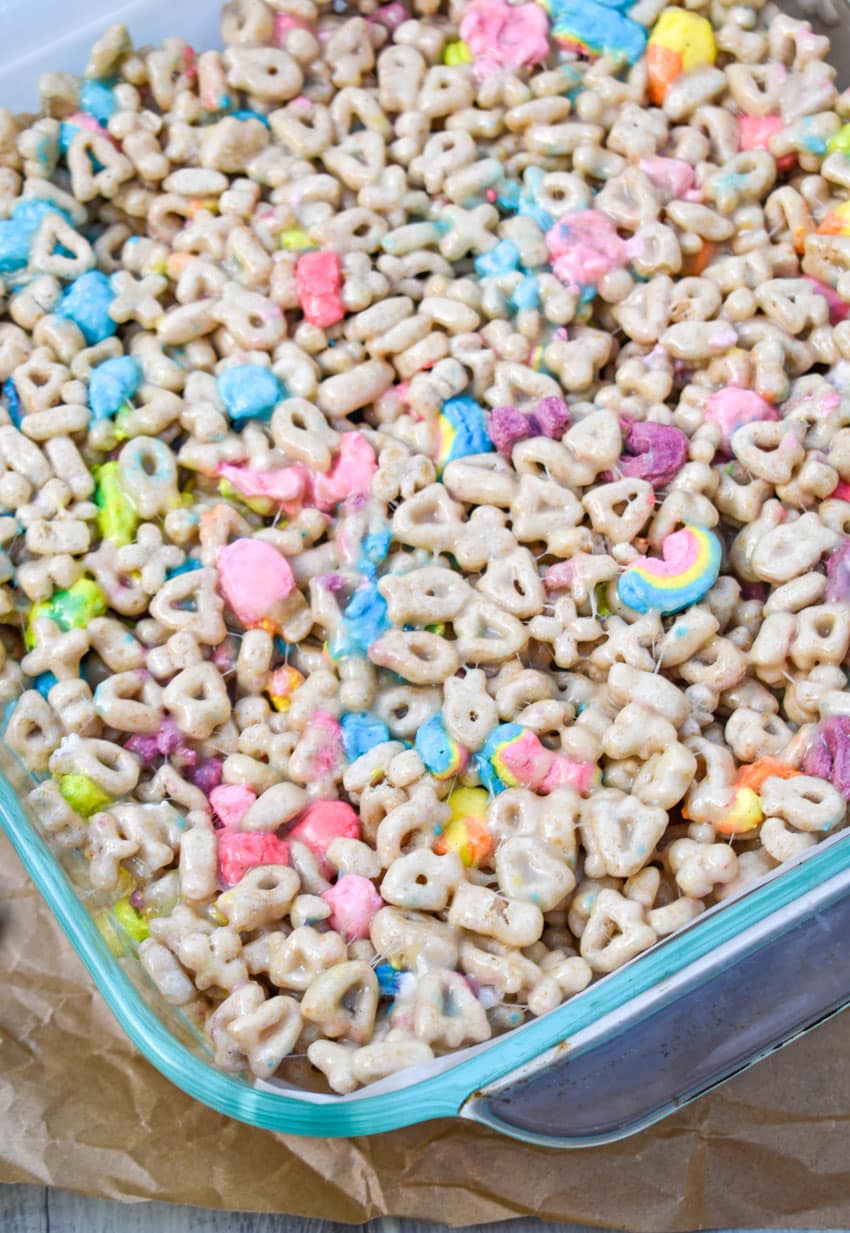 lucky charms treats in a white parchment paper lined square glass baking dish