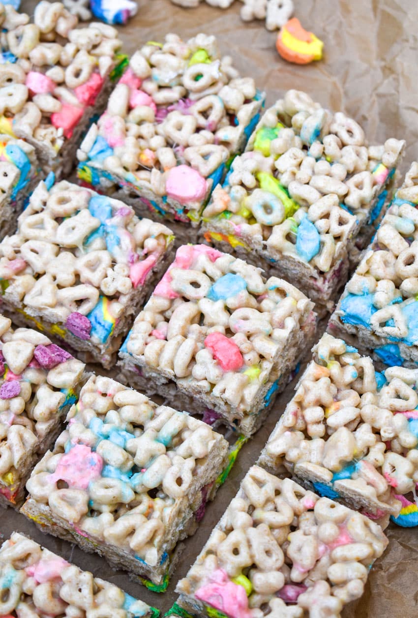 square cut lucky charms treats on wrinkled brown parchment paper
