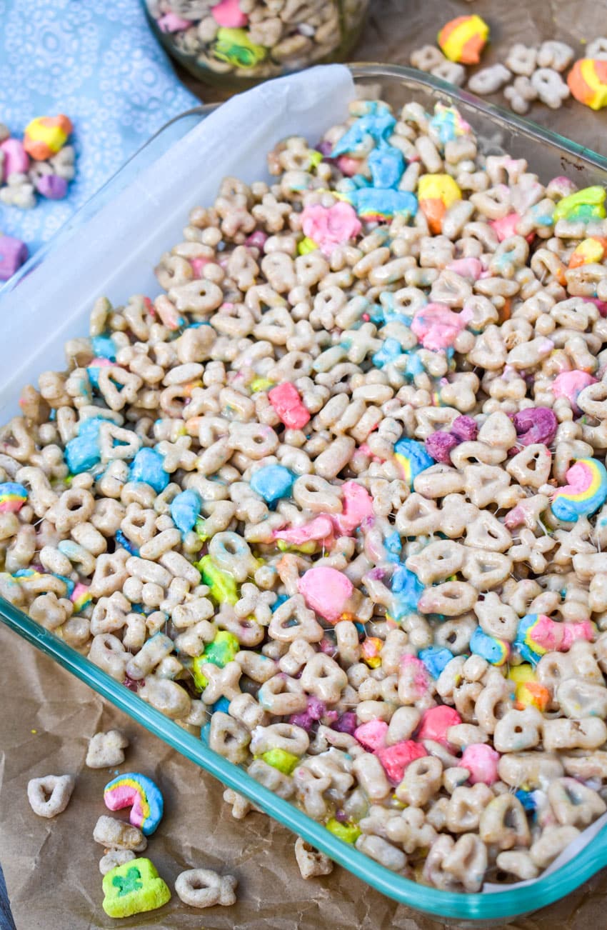 lucky charms treats in a white parchment paper lined square glass baking dish