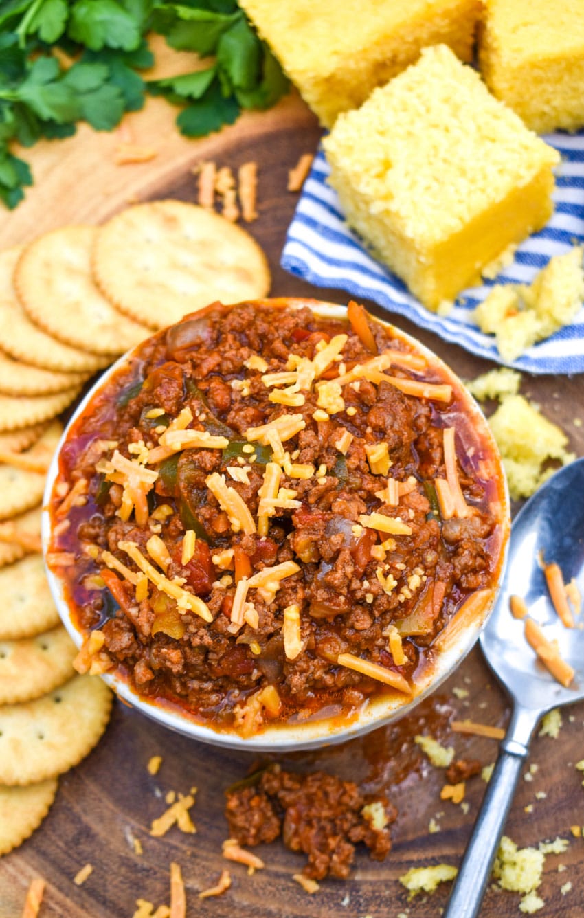 easy no bean chili recipe in a white bowl topped with shredded cheese