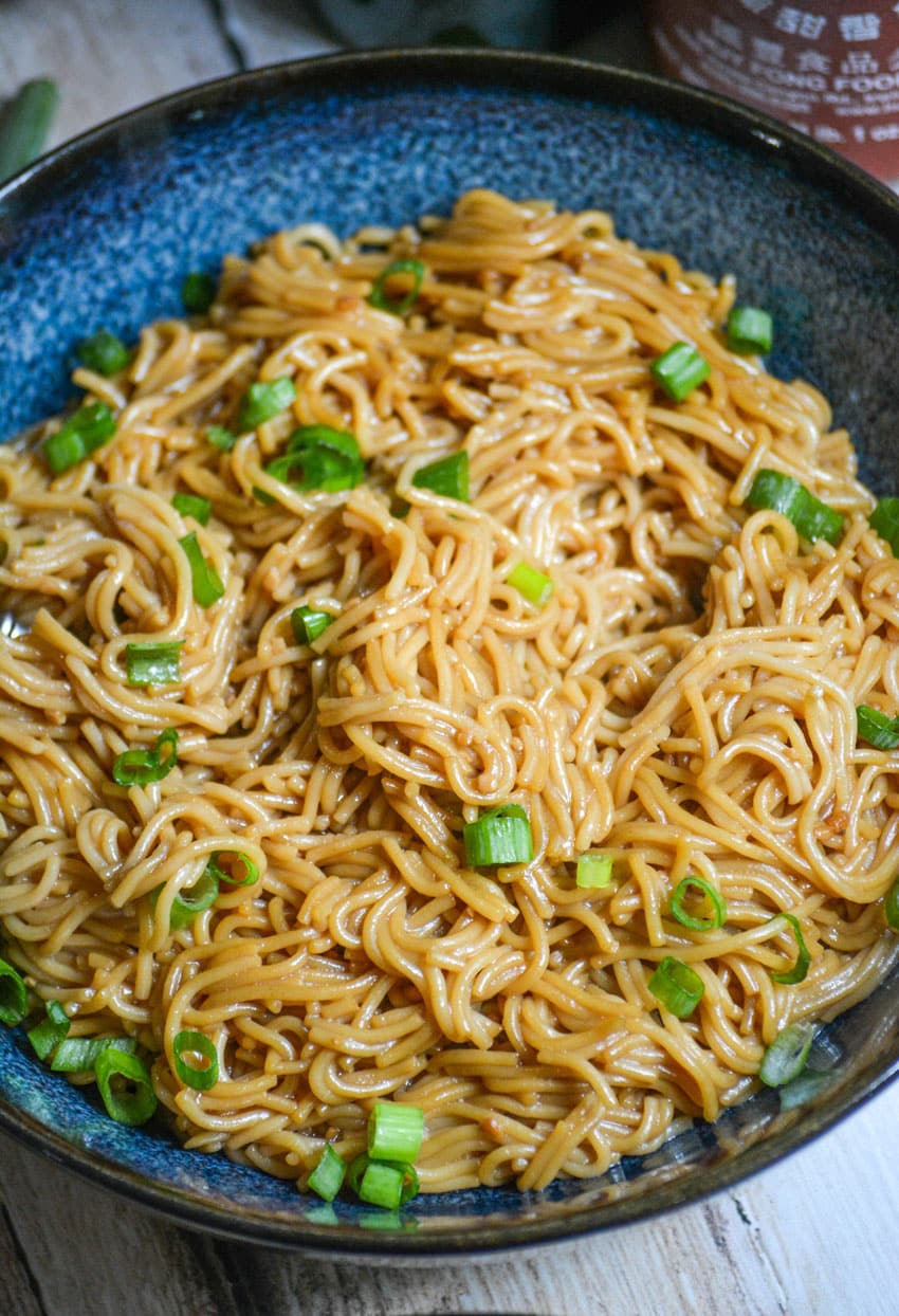sesame garlic ramen noodles in a blue bowl