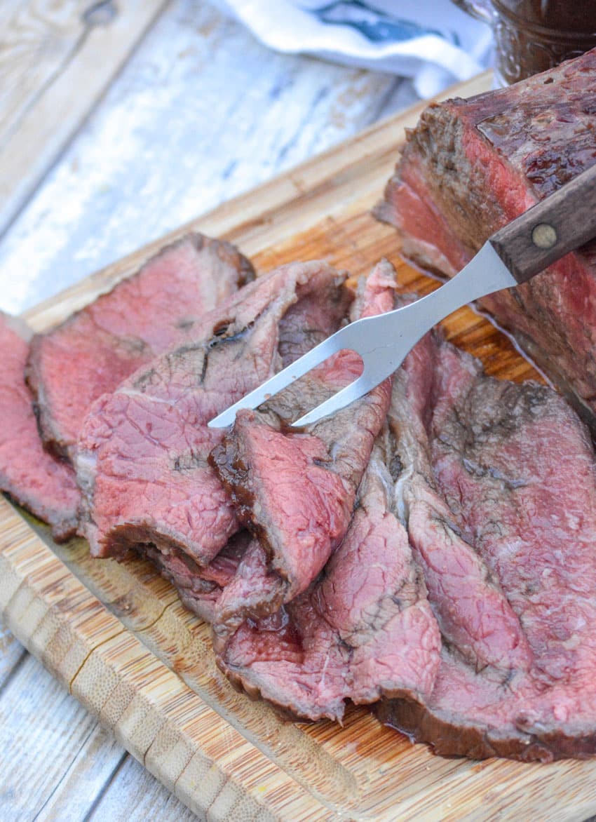 Worcestershire Marinated Bottom Round Roast slices of worcestershire marinaded bottom round roast on a wooden cutting board