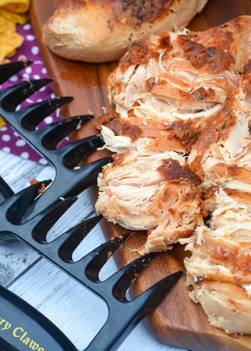 slow cooker cool ranch chicken on a wooden cutting board