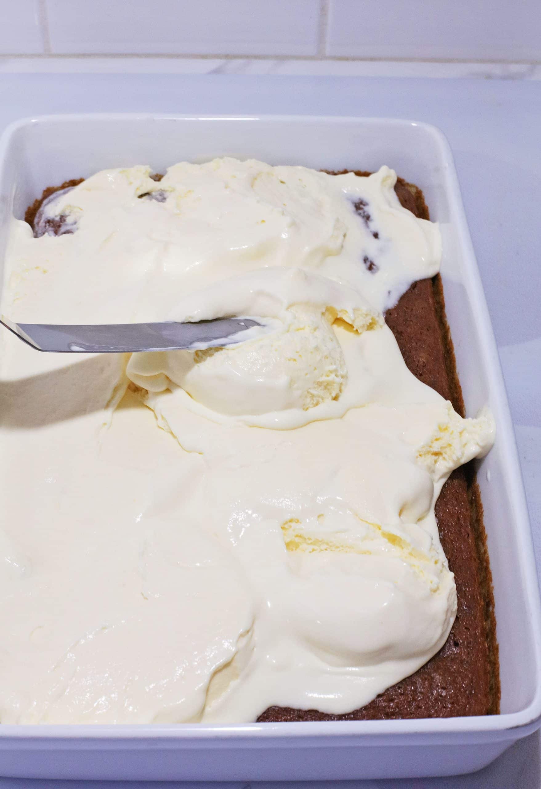 a layer of softened vanilla ice cream spread over a baked carrot cake