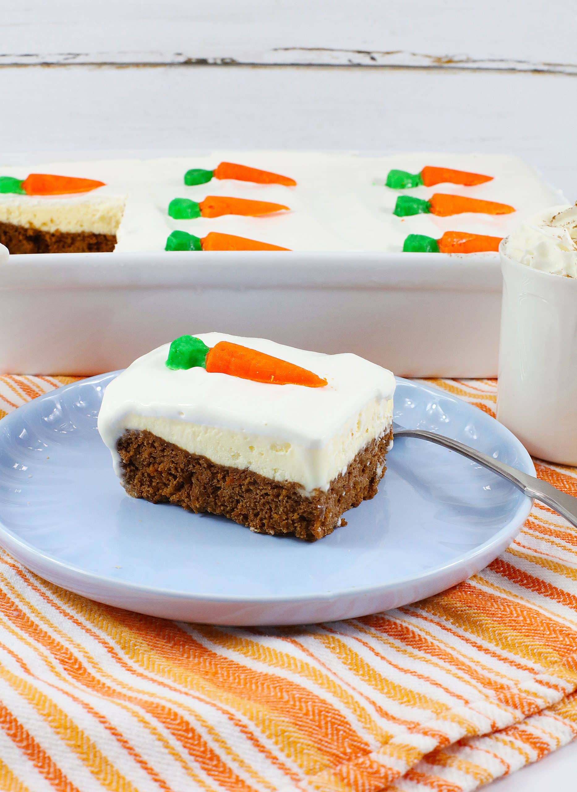 a slice of carrot cake ice cream cake on a light blue plate