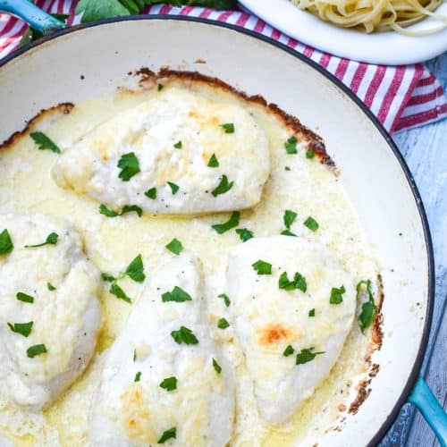 four pieces of creamy caesar chicken in a large cast iron skillet