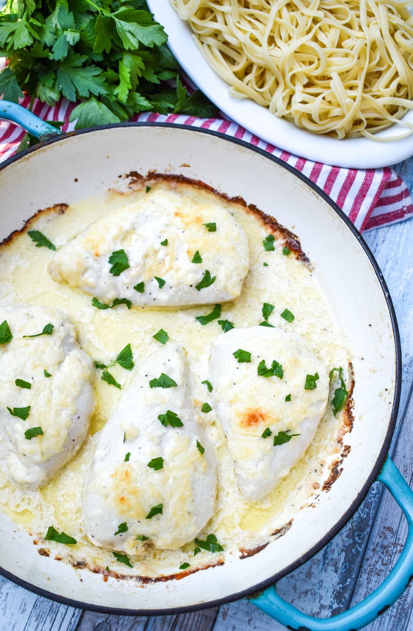 four pieces of creamy caesar chicken in a large cast iron skillet