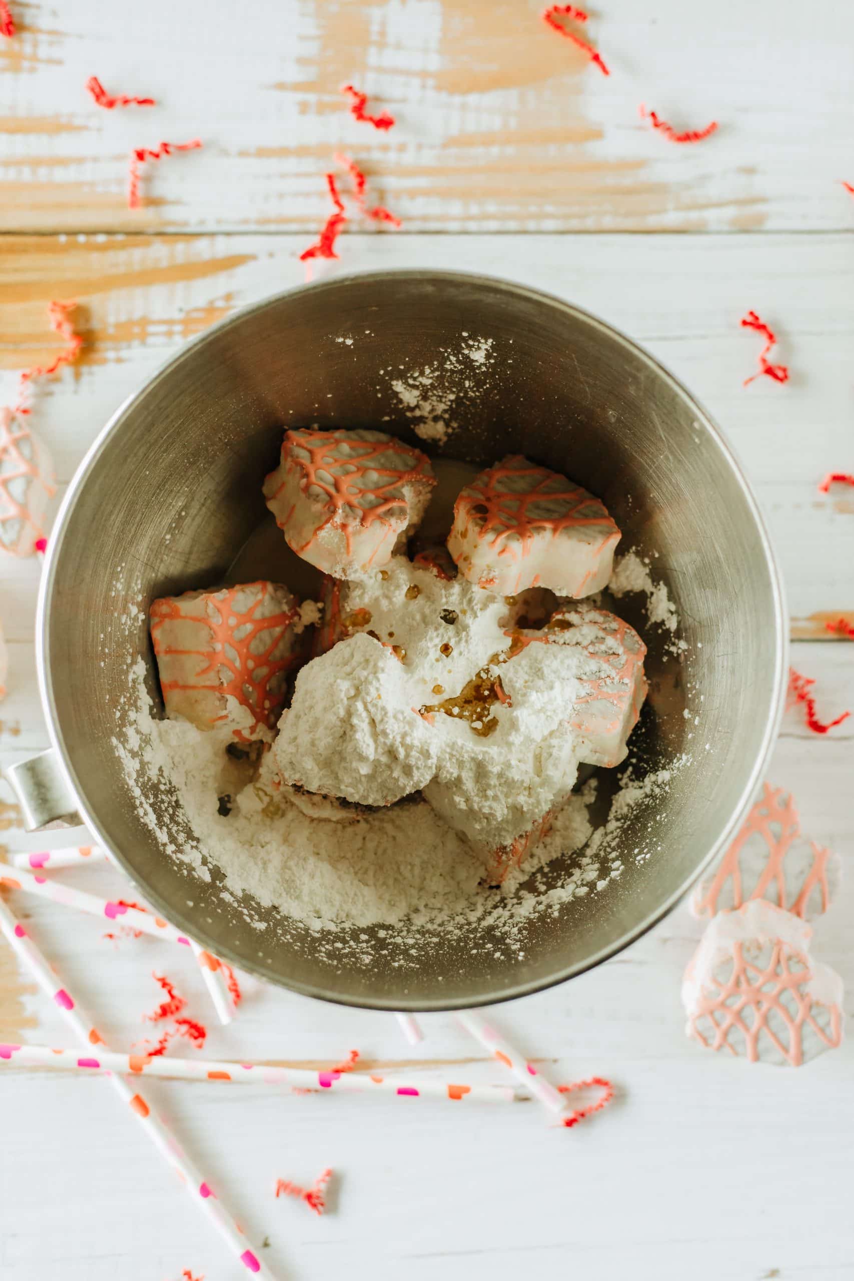 little debbie valentine's snack cakes and powdered sugar and cream cheese in a metal mixing bowl