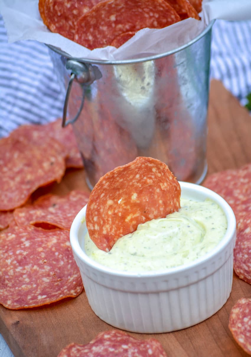salami chips on a wooden cutting board