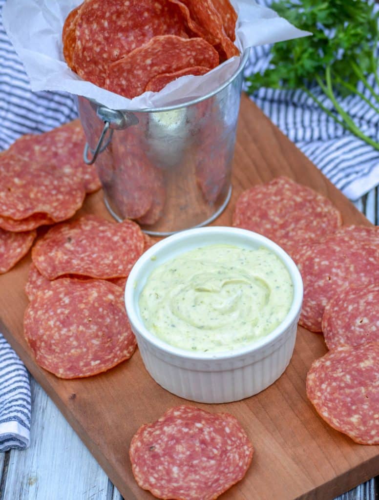 salami chips on a wooden cutting board