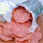 salami chips on a wooden cutting board