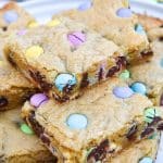 cut squares Easter cookie bars stacked on a white plate