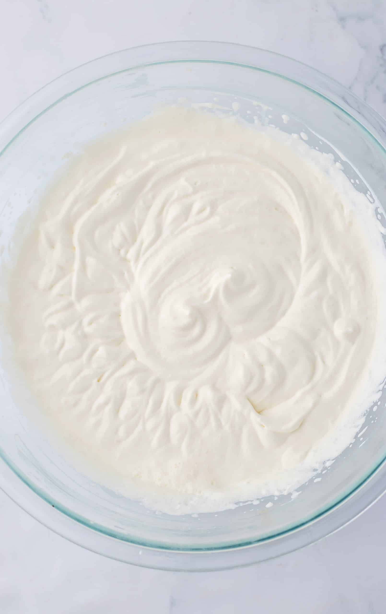 whipped cream in a large glass baking dish