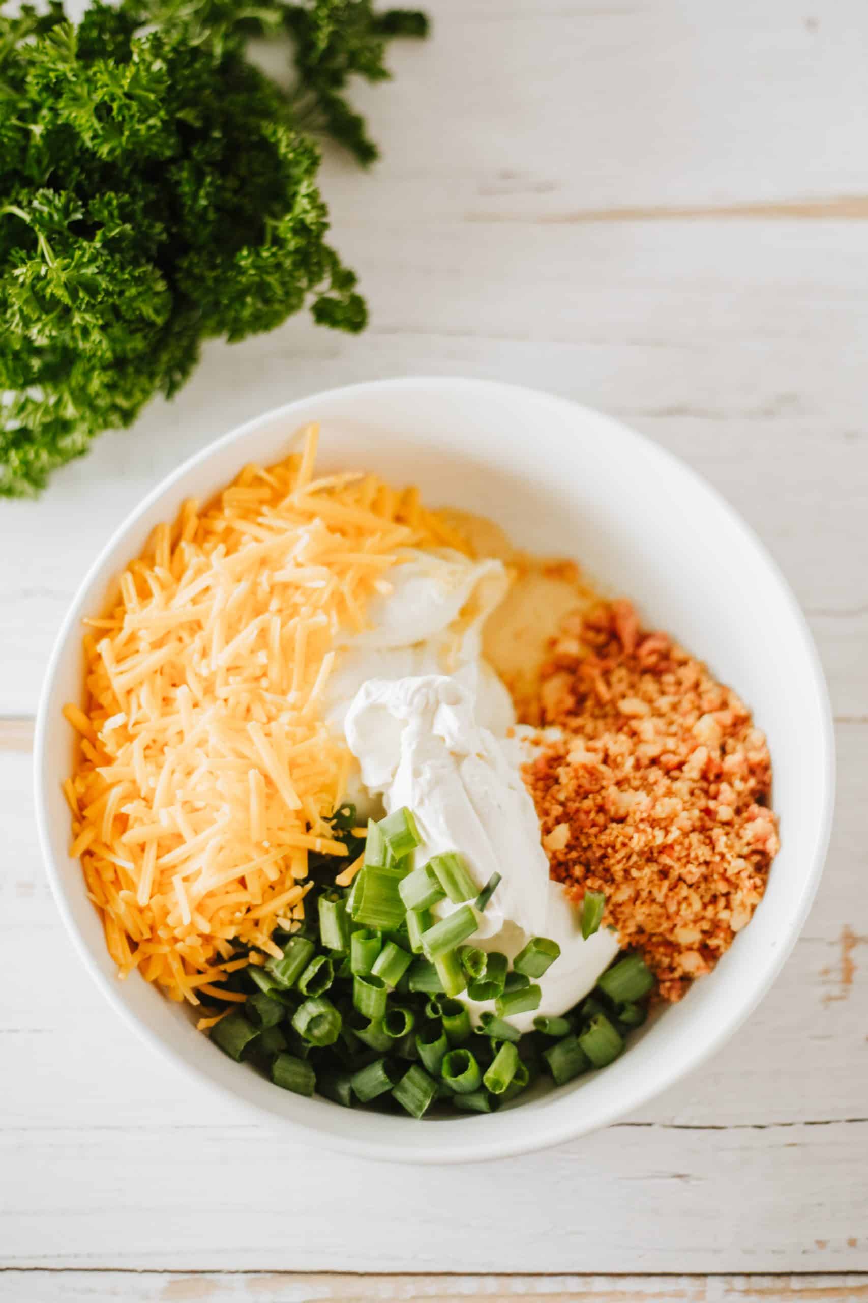 bacon cheddar cream cheese ingredients in a white bowl