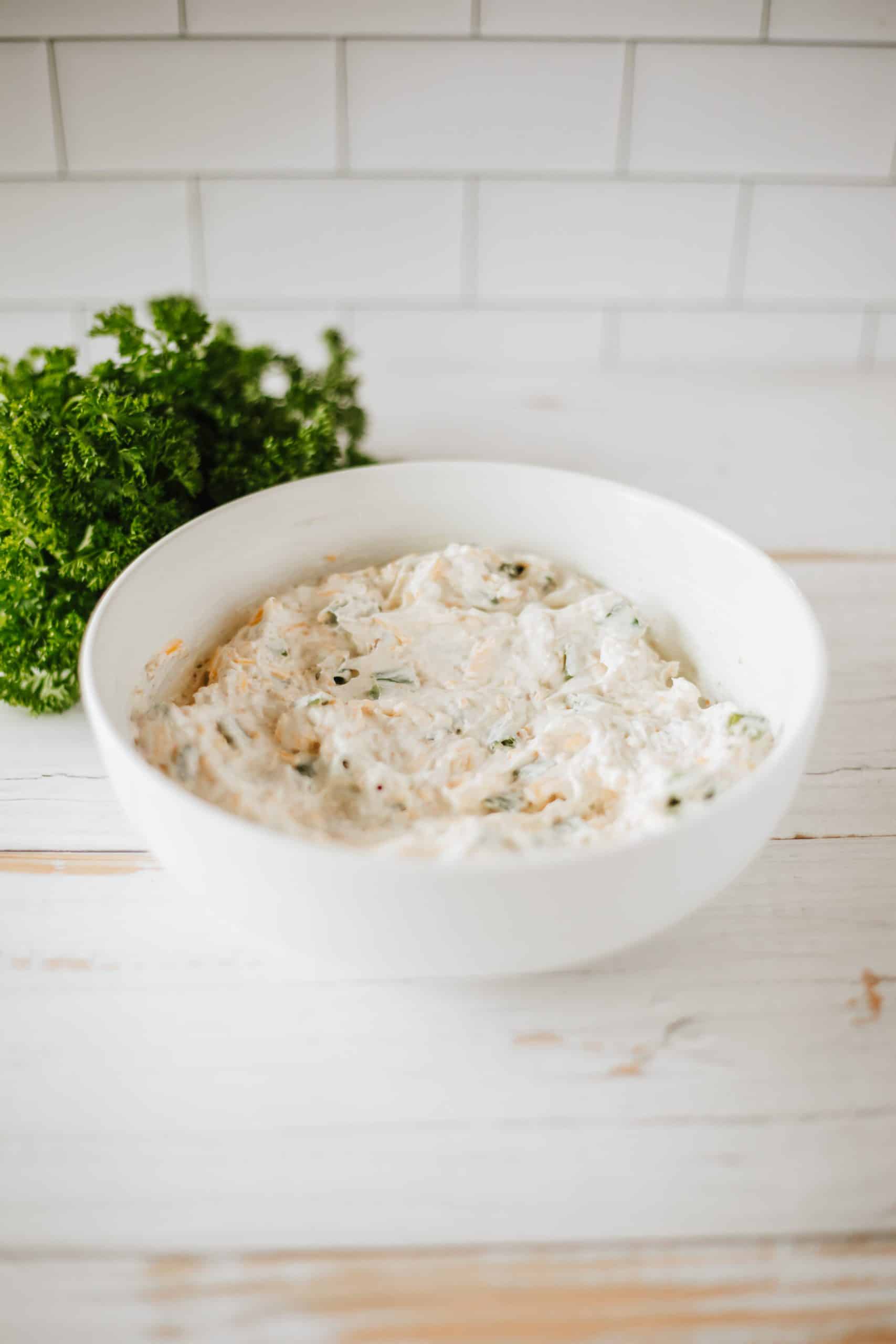 bacon cheddar cream cheese mixture in a large white bowl
