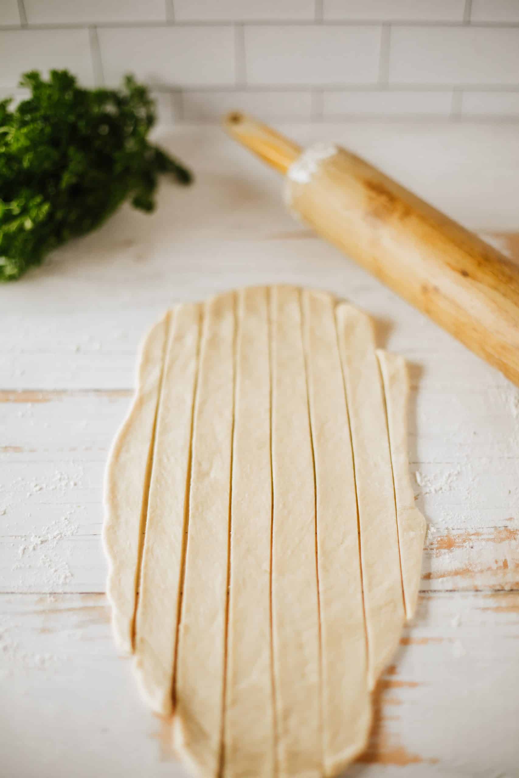 crescent roll dough rolled out an a wooden board