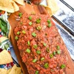 a mexican meatloaf on a wooden cutting board